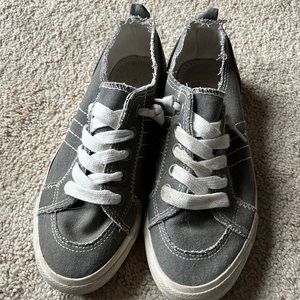 A gray canvas, tennis shoes